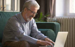 Older man using a laptop, aging, ageism